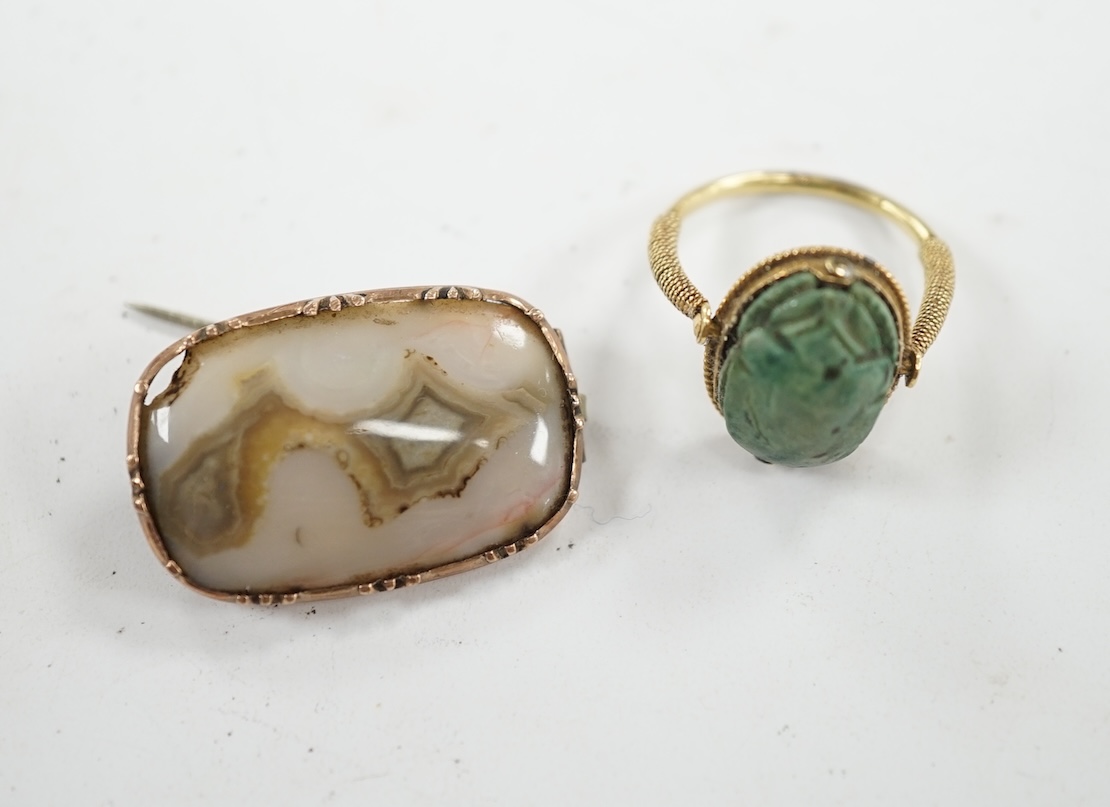 An antique yellow metal 'Scarab' ring and a banded agate set brooch. Condition - poor to fair